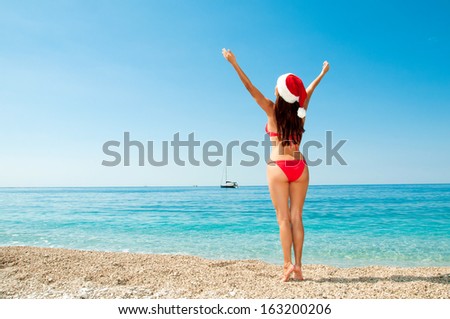 Christmas vacation on a beach resort. Brunette on the beach.