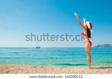 Christmas vacation on a beach resort. Brunette on the beach.
