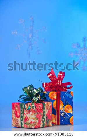Two New Year\'s gifts in festive packaging. Red box with green ribbon, blue box with red ribbon