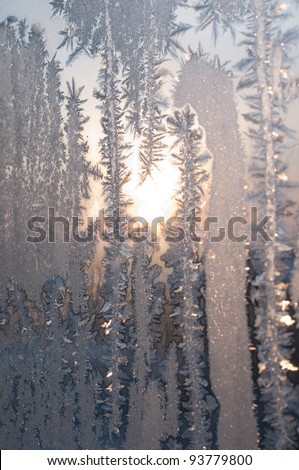 Sun for a frosty window. Dawn in the winter morning.