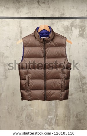 brown waterproof nylon waistcoat on a coat rack