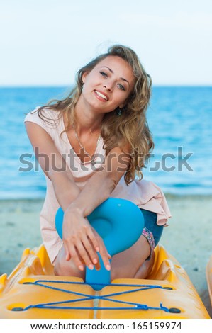 young woman sitting on the boat at the seaside
