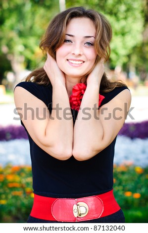 young woman in the dark dress in the summer park