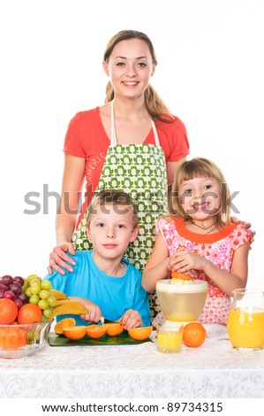 mother, daughter and son at the kitchen cooking an orange juice