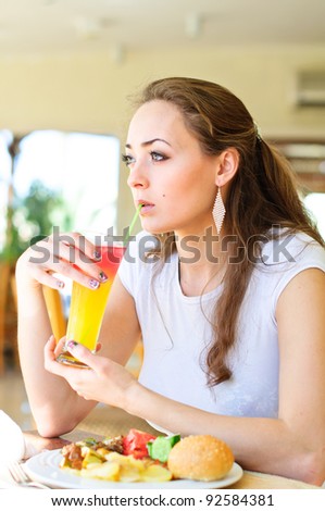 Closeup of a pretty young lady drink cocktail