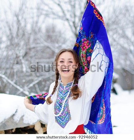 young beautiful woman in national ukraine suite at snowy winter