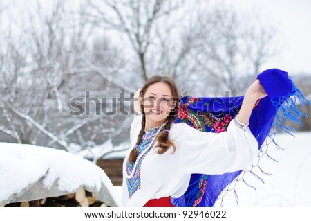 young beautiful woman in national ukraine suite at snowy winter