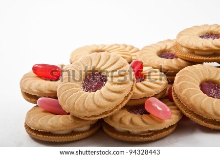 Sweet cookies with jam isolated on white with candy