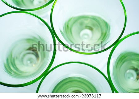 Transparent green glasses on white background