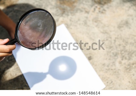 Scientific experiments. Use a magnifying glass to light the White Paper.