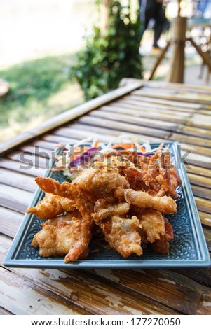 Soft Shell Crab fried with garlic on plate in restaurant.