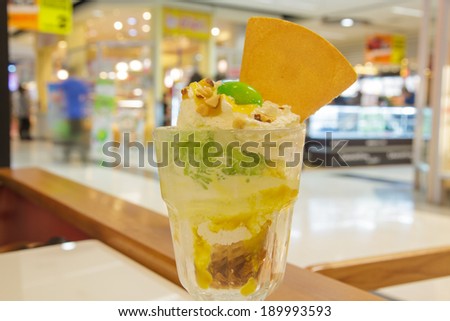 Ice cream mango in glass on ice cream shop.