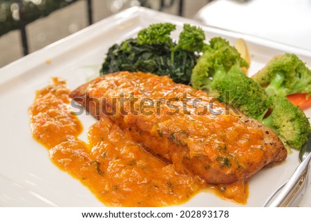 Grilled fish white sea bass with spicy sauce.