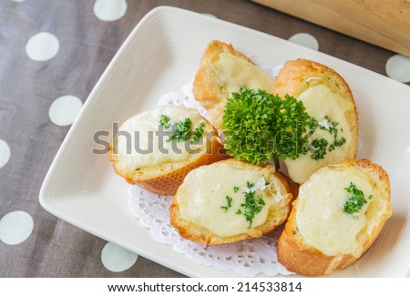 Cheese toast on white dish in restaurant