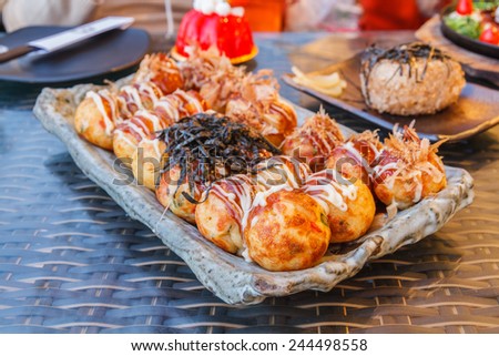 Japan food : Grilled dough to a circle stuffed squid in restaurant.