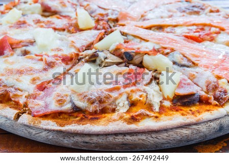 Pizza Hawaiian with ham mushroom pineapple and Salmon pizza in restaurant.