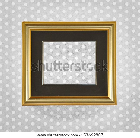Beautiful blank ancient frame on a retro dotted wall