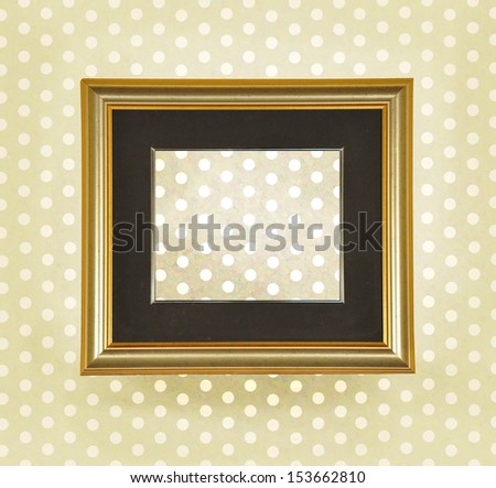 Beautiful blank ancient frame on a retro dotted wall