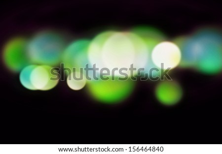 Beautiful blurred blue-green lights on a dark background