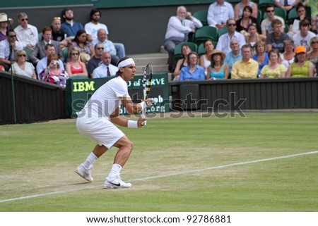LONDON - JUNE 24: Rafael Nadal of Spain returns ball during second round match against Robin Haase of the Netherlands at Wimbledon in London, England on June 24, 2010