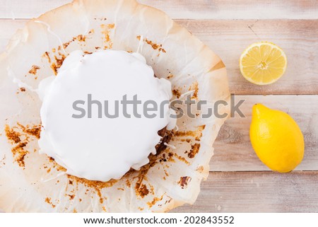 Lemon cake with white icing and fresh lemons