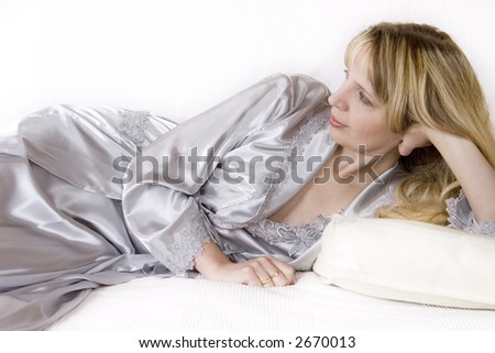 A women in a silk robe relaxing on the sofa and waiting