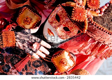 A venetian woman wearing a fancy orange and black costume