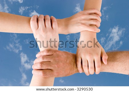 Four hands joined together