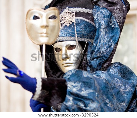 A man in a golden mask and blue costumer at the Venice carnival