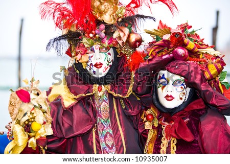 Red and gold fancy costumes at the Venice Carnival