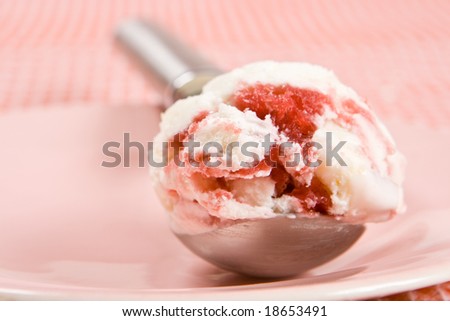 Scoop of raspberry ice cream on a pink plate