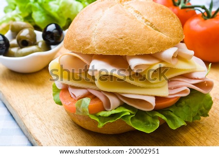 Delicious ham, cheese and salad sandwich with olives