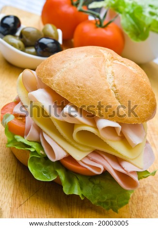 Delicious ham, cheese and salad sandwich with olives