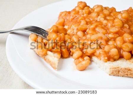 Delicious baked beans on toast with a fork