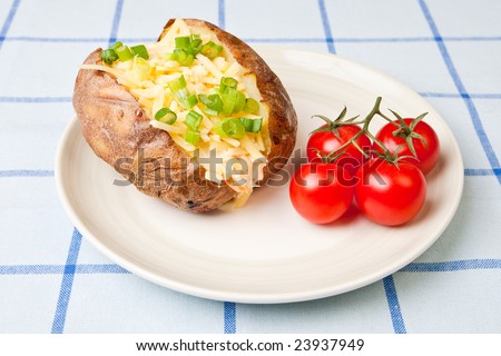 Hot and crispy baked potato stuffed with cheddar cheese, coleslaw and tomatoes