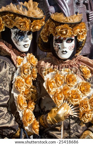 Gold costume with golden roses at the Venice Carnival