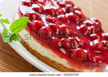 Delicious strawberry cheese cake with fresh mint on a white plate