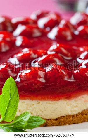 Delicious strawberry cheese cake with fresh mint on a white plate