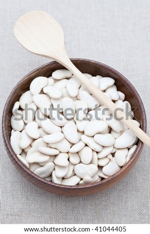 White butter beans in a wooden dish