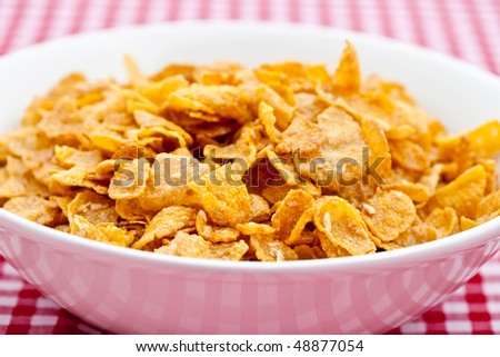 Breakfast cereal in a white bowl on a red table cloth