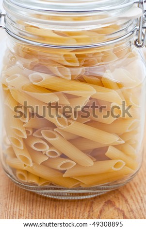 Dried pasta tubes in a large glass jar