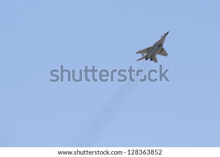 ALBACETE,SPAIN - APRIL 11: Military fighter jet during demonstration in Albacete air base, Los Llanos, Aerobatic Spanish patrol perform at an airshow (TLP) on April 11, 2012 in Albacete,Spain