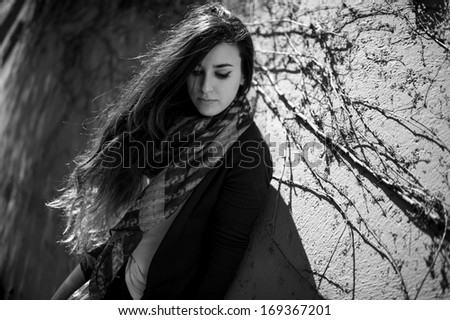 Young beautiful woman portrait looking down in black a white.