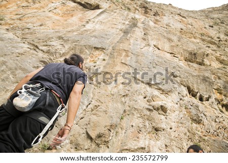 Man looking up at the mountain he is about to climb