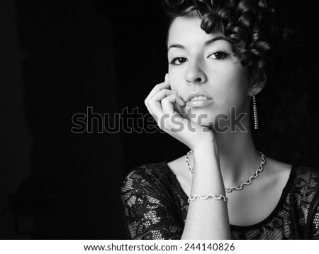 Beautiful young woman portrait. Jewelry and diamonds. Image on black and white.