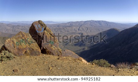 Desert mountain landscape with graffiti on rocks