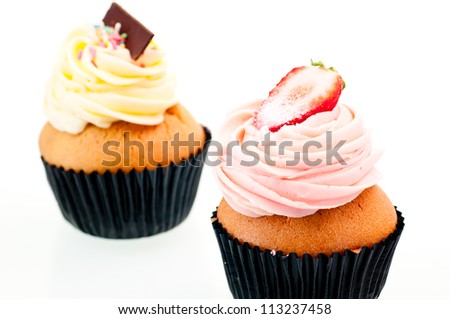Strawberry and vanilla cup cake close up over white background