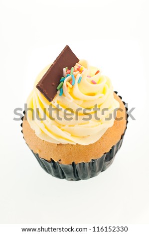 Vanilla cupcake vertical close up over white background