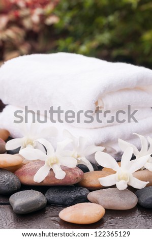 Outdoor spa concept with white orchids and zen stones