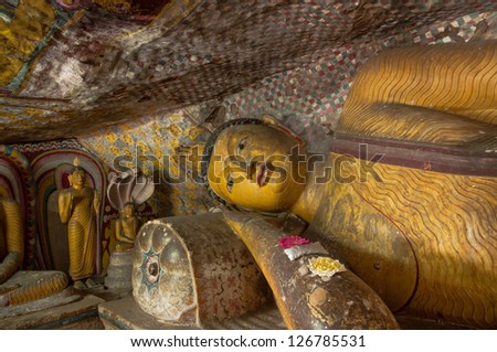 Reclining Buddha statue close up at Dambulla Cave Temple, Sri Lanka. Dambulla Rock Temple is a Unesco World Heritage Site.